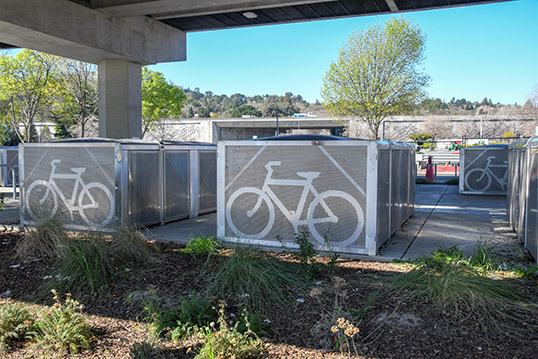 Image of about 5 large metal bike storage structures. 