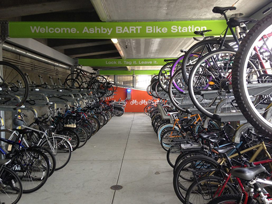 The inside of the Ashby BART Bike Station with several parked bikes.